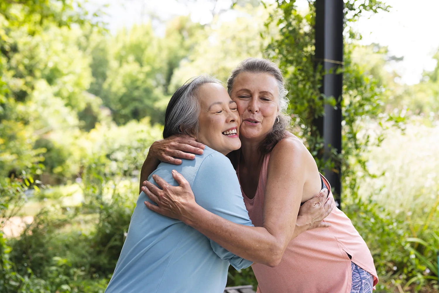 two smiling women share an embrace
