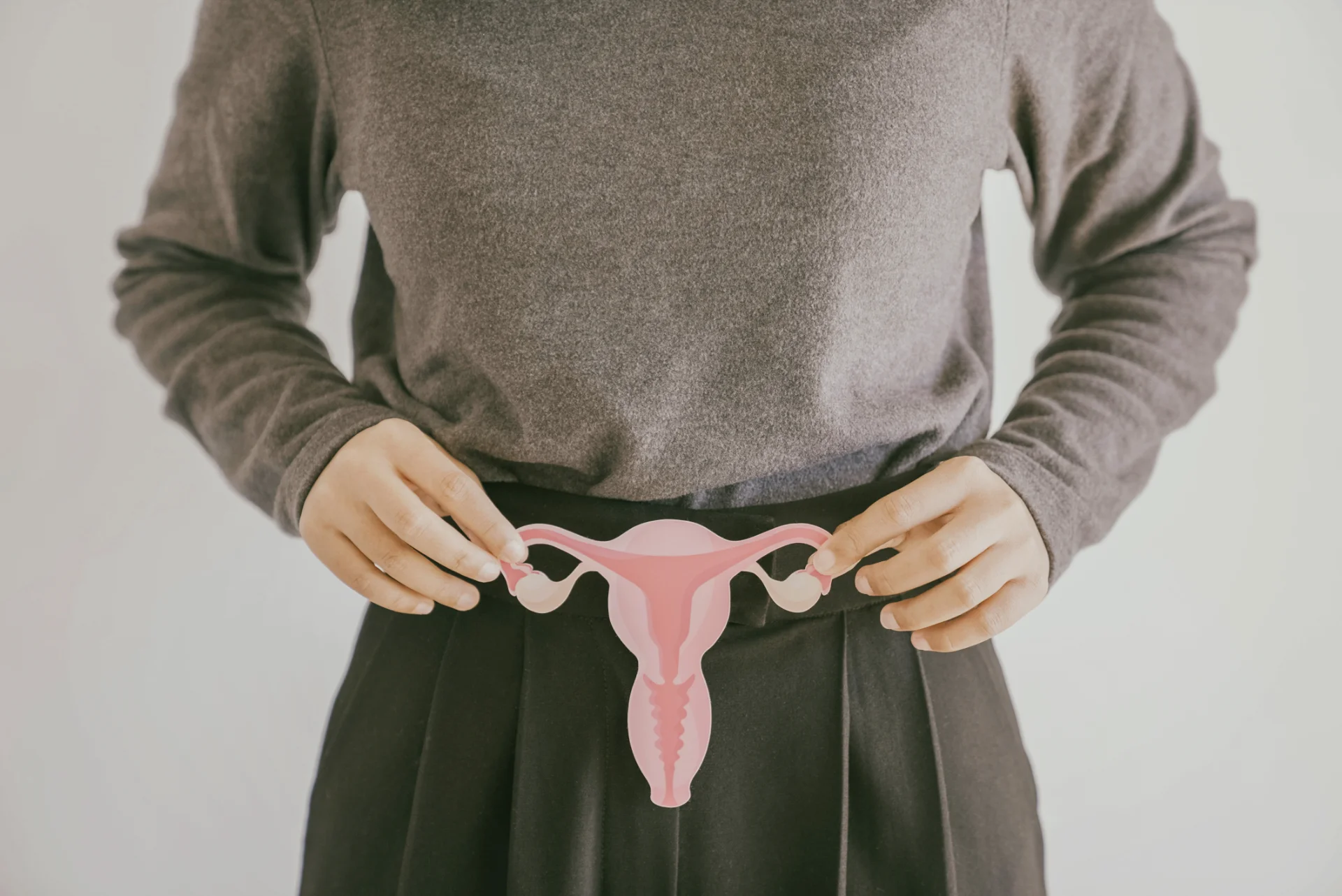 woman holding uterus diagram in grey toned photo 2026 03 09 08 43 49 utc
